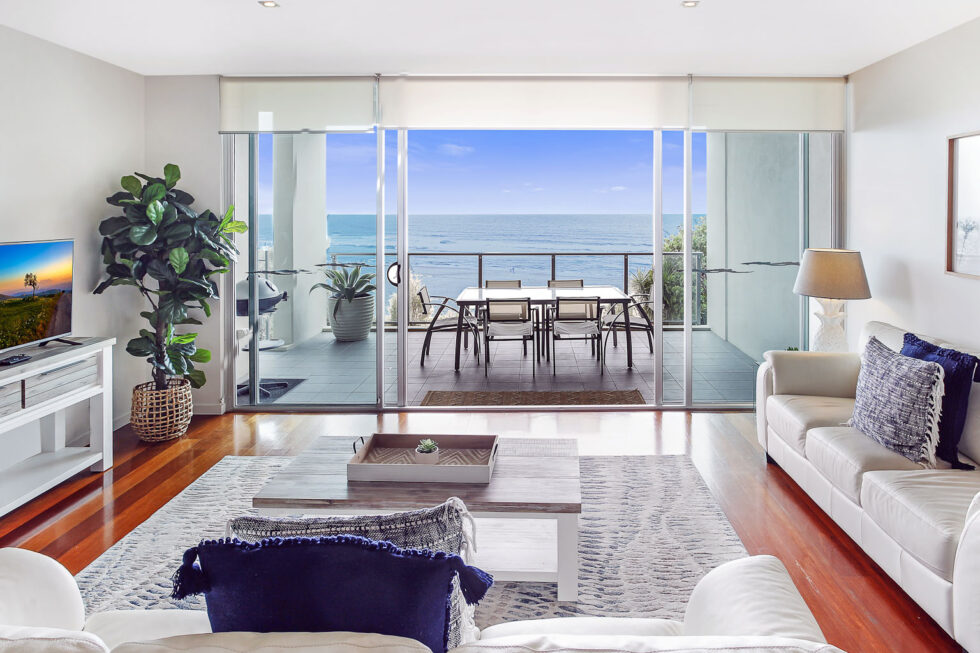 Pool View 2 Bedroom Apartment living room opening to ocean view balcony
