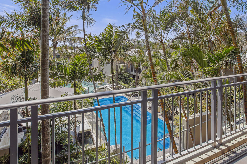 Pool View 2 Bedroom Apartment balcony view over pool and palms