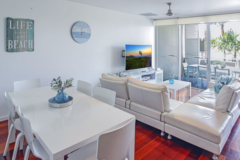 Pool View 2 Bedroom Apartment living and dining area opening to balcony