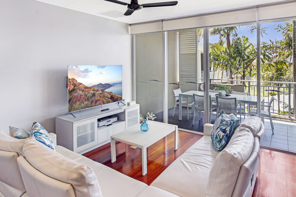Pool View 2 Bedroom Apartment living room with balcony and pool view