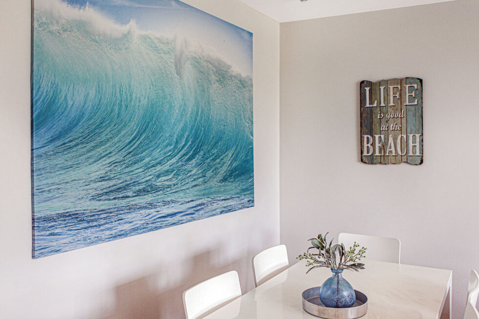 Pool View 2 Bedroom Apartment dining area with wave artwork