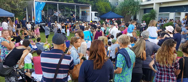 Crowds enjoying live music and community festivities at an outdoor stage, one of the popular things to do in Cabarita Beach during the holiday season.